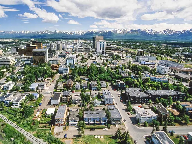 Aerial view of downtown Anchorage, Alaska, with the Chugach Mountains in the background